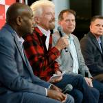 Richard Branson (second from left), founder of Virgin Atlantic and the Virgin Group, speaks at a news conference as he sits with Lance Lyttle (left), Managing Director of the Port of Seattle; Craig Kreeger (second from right), CEO of Virgin Atlantic; and John Caldwell (right), Seattle vice president of Delta Air Lines, on Monday, March 27, at Sea-Tac Airport. (AP Photo/Ted S. Warren)
