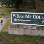 Andy Bronson / The Herald                                Two women walk dogs at Wiggum&rsquo;s Hollow Park, named for Arnie Wiggum, on Friday in Everett. A character on the animated TV show &ldquo;The Simpsons&rdquo; is also named for the Everett native.
