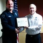 Mountlake Terrace Police Chief Greg Wilson receives a Patriotic Employer Award from Mike Kidd, Captain USN (Ret). (Contributed photo)