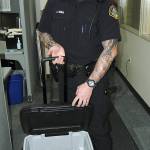 Monroe police officer Jake Eriks collected a cooler of marijuana earlier this week that apparently was donated to the Goodwill as an accident. Now police say the pot may be tied to a series of home-invasion robberies and dispensary burglaries. (Monroe Police Department)
