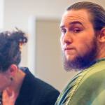 Standing at the bench with Snohomish County Public Defender Laura Martin just moments before Judge David A. Kurtz arrives and sentences Dean Connors to eight and a half years in prison, the convicted rapist glances past one of two Snohomish County Corrections officers guarding him Monday at Snohomish County Superior Court. (Dan Bates / The Herald)