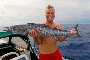 Andy Stephens holds a Wahoo fish caught from his 30-foot sailboat about 100 miles west of Pohnpei, Micronesia, in the Pacific. The 33-year-old Everett native left on a round-the-world sailing trip in July. He is home in Everett this month, but will soon fly back to the Philippines where his boat is now moored. (Courtesy Andy Stephens)