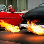 To the amazement of onlookers, flames shoot out the exhaust pipes on Les Sanders&rsquo; black 1950 Mercury Coupe as he drives up and down Colby Avenue with many others in classic and custom automobiles during one of the many popular Cruzin&rsquo; to Colby events held each summer in Everett. (Dan Bates / The Herald)