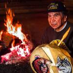 In the Tulalip Tribes&rsquo; sacred long house on Tulalip Bay in April 1999, Raymond Moses prepares a warm fire before meeting with youngsters from Pinewood Elementary School in Marysville. (Dan Bates / Herald file)