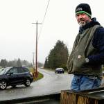 Todd Macomber stands where many a speeding car coming down 100th Street NE used to fly right out onto the Macomber Farm pasture before the county put up guardrails. There are 14 such problem curves on which the county plans to apply a high-friction surface treatment this summer. (Dan Bates / The Herald)
