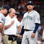 Seattle Mariners pitcher Felix Hernandez is checked out by manager Scott Servais and a trainer in the fourth inning of Monday&rsquo;s game in Houston. (AP Photo/Eric Christian Smith)