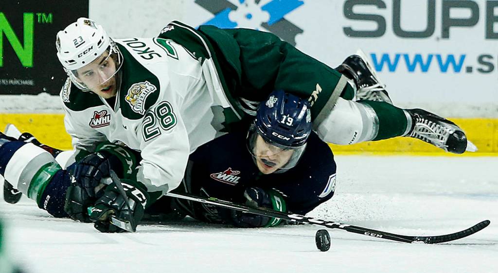 Silvertips right wing Devon Skoleski (28) battles for the puck with Seattle&rsquo;s Donovan Neuls (19) during the first game of their second-round playoff series on April 7, 2017, at Xfinity Arena in Everett. (Ian Terry / The Herald)