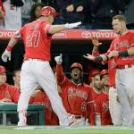 Los Angeles Angels&rsquo; Mike Trout (left) celebrates his two-run home run that was the difference in the Angels&rsquo; 5-4 win over the Mariners on Saturday in Anaheim, California. (AP Photo/Jae C. Hong)