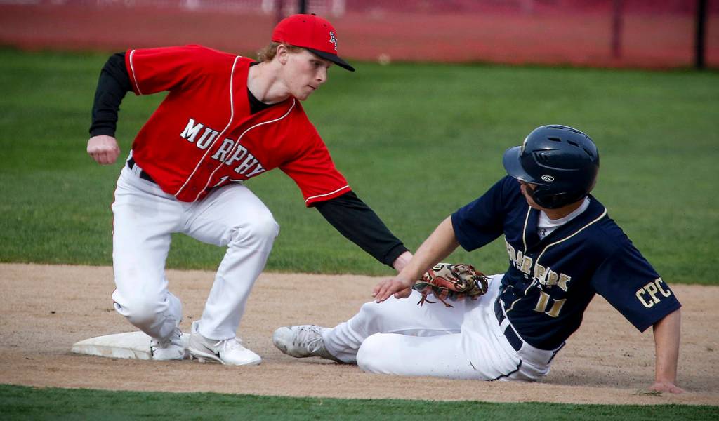 Archbishop Murphy second baseman Austin Hauck (left) tags out Cedar Park Christian&rsquo;s Luke Lampe on a steal attempt in the fourth inning of a game on Aprilo 11, 2017, at Archbishop Murphy High School in Everett. (Ian Terry / The Herald)