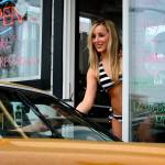 A barista serves a customer at a Cowgirls Espresso stand on Broadway in Everett in May of 2008. The city of Everett may consider an ordinance that would adopt a dress code for baristas that would ban binkinis and require more modest attire. Stand owners would be fined if employees violated the dress code. (Kevin Nortz / Herald file photo)