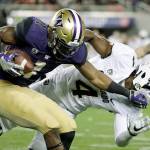 Washington&rsquo;s John Ross (1) stiff-arms Colorado&rsquo;s Chidobe Awuzie (4) during the Pac-12 championship game on Dec. 2, in Santa Clara, Calif. Ross is widely projected as a first-round pick in the upcoming NFL draft. (AP Photo/Marcio Jose Sanchez)