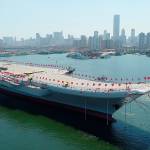 A new aircraft carrier is transferred from dry dock into the water in Dalian, China, on Wednesday. (Li Gang/Xinhua)