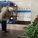 A woman pays her respects at a impromptu memorial at Tekhnologichesky Institute subway station in St. Petersburg, Russia, on Tuesday. A bomb blast tore through a subway train deep under Russia&rsquo;s second-largest city Monday, killing 14 people and injuring dozens more. (AP Photo/Dmitri Lovetsky)