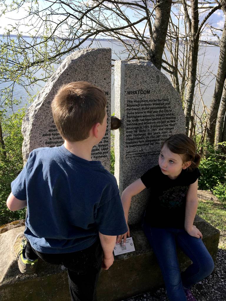Charlie and Grace Swaney check out the the Fairhaven-Whatcom boundary marker along the South Bay Trail. (Aaron Swaney / The Herald)