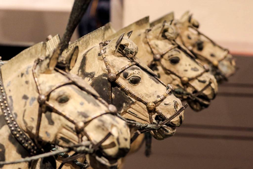 Terra-cotta horses drawing a chariot are on display as part of the First Emperor exhibition at the Pacific Science Center in Seattle. The two-city USA tour features 10 full-size statues and more than 100 artifacts. (Kevin Clark / The Herald)