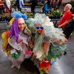 As part of Earth Week, Dan Bauer (left) and William Frankhouser, aka &ldquo;Bagfoot(s),&rdquo; each wear 550 plastic bags, the average number a single human tosses out each year, during Everett Community College&rsquo;s annual plant swap at Whitehorse Hall on Tuesday. When the baggy duo are working, they are part of the college&rsquo;s IT team. (Dan Bates / The Herald)