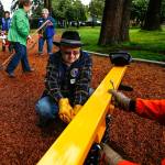 Lions Club volunteer Roy Johnson (center) gets some help tightening spring mounting bolts on a play structure from Ray Drake (right), who is with Arlington Maintenance and Operations, earlier this week. Other Lions volunteers Maxine Jenft (green), local Lions President Joan Flesher (back left) and 40-year member Donna Knight tidy up the bark as they near completion of their work on a new children&rsquo;s playground at Terrace Park in Arlington. (Dan Bates / The Herald)