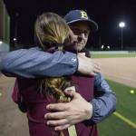Lakewood freshman pitcher Kassidy Millar hugs her father Everett coach Mike Millar after the Cougars lost 12-6 to Everett on Monday in Everett. (Andy Bronson / The Herald)