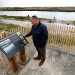 Jim Ballew, Marysville&rsquo;s parks and recreation director, looks at a new sign on the new Qwuloolt Waterfront Trail on Tuesday in Marysville The new trail runs from Ebey Waterfront Park to the Qwuloolt Estuary. (Andy Bronson / The Herald)