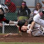 Snohomish&rsquo;s Josh Johnston beats the tag at home by Marysville Pilchuck catcher Jordan Luton during a game April 18, 2017, in Snohomish. (Andy Bronson / The Herald)