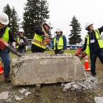 Jacob Smithies takes a selfie as fellow teens try out various tools on a concrete block during the Trade UP event at the Arlington Airport on Tuesday. (Andy Bronson / The Herald)
