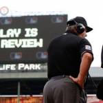 Umpire Joe West (22) communicates with MLB&rsquo;s review command center in New York during a game last May between the Texas Rangers and the Cleveland Indians. (AP Photo/Brandon Wade)