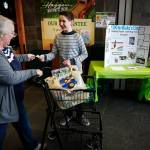 Blake Habersetzer, 12, collects a donation from Patty Dobbs outside the Haggen supermarket in Snohomish on Wednesday. Blake is aiming to collect $13,000 for his upcoming 13th birthday to donate to help tackle Somalia&rsquo;s ongoing drought crisis. (Ian Terry / The Herald)