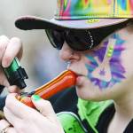 A woman smokes a pipe during a 4/20 rally on Parliament Hill in Ottawa, on Thursday, April 20. (Sean Kilpatrick/The Canadian Press via AP)
