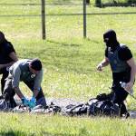 French police officers collect bags at a hideout used by Basque separatist guerrillas in Saint Pee sur Nivelle, France, on Saturday. (AP Photo/Bob Edme)