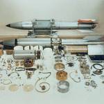 B61 bombs in various stages of assembly. The nuclear warhead is contained in the small, silver cylinder near the upper middle. (Wikipedia)