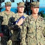 Petty Officer 1st Class Nicole Cimino (right), of Port Security Unit 313 in Everett, performs colors for the 75th anniversary of the Coast Guard Reserves while deployed in Guantanamo Bay, Cuba. (U.S. Coast Guard photo)