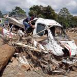 A man looks inside a damage bus in Mocoa, Colombia, on Sunday. Authorities said more than 250 people, many of them children, were killed in a mudslide and flood. (AP Photo/Fernando Vergara)