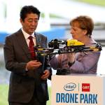 German Chancellor Angela Merkel and Japanese Prime Minister Shinzo Abe look at a drone during a trade fair in Hanover, Germany, in March. (Friso Gentsch/dpa)