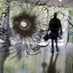 A bullet hole in a shopwindow of the Champs Elysees boulevard in Paris on Friday. (AP Photo/Christophe Ena)