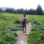 Jerry Weatherhogg, of Everett, hikes through Spray Park near Mount Rainier with his daughter Hazel on his back in September 2011. With spring training, you too can conquer hiking trails like this come summertime. (Jessi Loerch / Herald file)