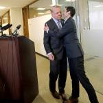 Seattle Mayor Ed Murray is greeted by his husband, Michael Shiosaki, after reading a statement to the media on Friday, April 7, in Seattle. (AP Photo/Elaine Thompson)
