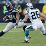 Seahawks running back Marshawn Lynch (24) carries the ball while Panthers defensive back Cortland Finnegan (26) closes in during a game Jan. 17, 2016, in Charlotte, N.C. (AP Photo/Bob Leverone)