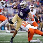 Washington&rsquo;s Dante Pettis (8) twists to avoid Oregon State defenders as he scores on a 23-yard pass reception in the first half of a game Oct. 22, 2016, in Seattle. (AP Photo/Elaine Thompson)