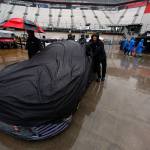 A crew team pushes a car through the rainy pit area before for a Monster Energy Cup Series race April 23, 2017, in Bristol, Tenn. The race was postponed due to weather. (AP Photo/Wade Payne)