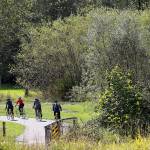 Cyclists ride down the Centennial Trail near the Nakashima Barn north of Arlington. This trail is the author&rsquo;s favorite route to cycle in the Marysville-Arlington area. (Genna Martin / Herald file)