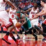 Boston Celtics guard Isaiah Thomas (4) dribbles through the Chicago Bulls&rsquo; defense Sunday during the teams&rsquo; NBA playoff game in Chicago. (AP Photo/Charles Rex Arbogast)