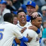 Seattle Mariners&rsquo; Nelson Cruz, right, is greeted by teammates including Leonys Martin, second from left, and Guillermo Heredia (5) after Cruz hit a walk-off single in the ninth inning to score Mariners&rsquo; Mike Freeman and give the Mariners a 8-7 win over the Texas Rangers, Sunday, April 16, in Seattle. (AP Photo/Ted S. Warren)