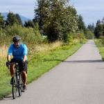 Nick Ridgeway, of Stanwood, bikes down the Centennial Trail outside of Bryant. He and his family walk and bike on the trail often. (Genna Martin / Herald file)