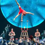 Strongman Ugo Laffolay performs a hand-balancing act while playing a lifeguard on a 1920s movie set in tribute to Mexican cinema in &ldquo;Luzia.&rdquo; (Matt Beard photo)