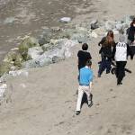 Beachgoers to Howarth Park walk by a rock bulwarks on Tuesday in Everett. (Andy Bronson / The Herald)