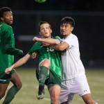 Lynnwood&rsquo;s Diego Aragon (right) grabs Edmonds-Woodway&rsquo;s Kyle Aure as they battle for the ball during a game on April 5, 2017, in Bothell. (Andy Bronson / The Herald)