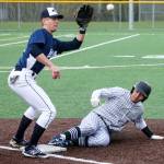 Edmonds-Woodway&rsquo;s Jacob Kitchen (right) beats the throw to Meadowdale&rsquo;s Hunter Shouse at third base during a game April 12, 2017, at Mountlake Terrace High School. (Kevin Clark / The Herald)
