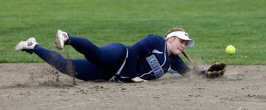 Meadowdale&rsquo;s Olivia Dimmock dives for a grounder during a game against Snohomish on April 25 in Snohomish. (Andy Bronson / The Herald)