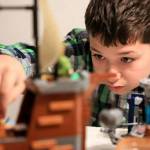 J.T. Fisher, 11, plays with Legos. Like his younger brother Colin, J.T. lives with autism. (Kevin Clark / The Herald)