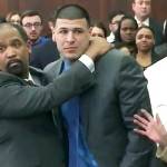 In this still image from video, Aaron Hernandez (center) is hugged by defense attorney Ronald Sullivan on Friday, April 14, in court in Boston, after being found not guilty of murder in the 2012 shootings of two men in a drive-by shooting in Boston. (WHDH-TV via AP, Pool)